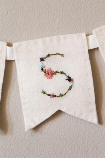 Detail shots of how to make custom DIY Hand embroidered, felt Bunting flags.